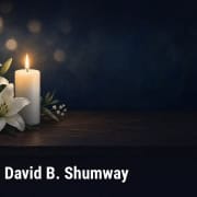Fostoria News Memorial candle and lilies for David B. Shumway obituary.